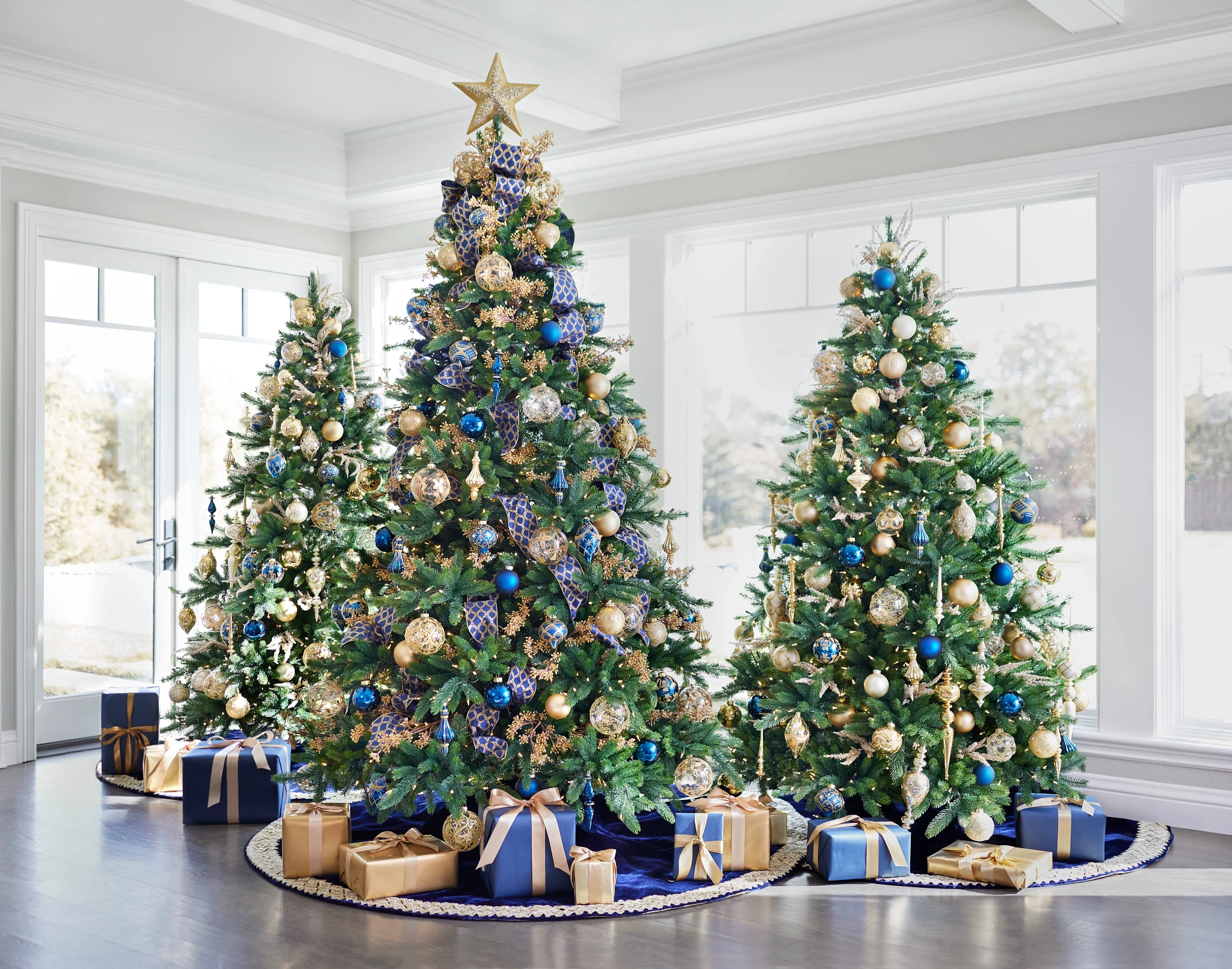 Set of Christmas trees decorated with blue and gold ornaments