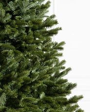 Close-up of artificial Christmas tree with realistic and traditional foliage