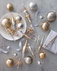 Gold and silver Christmas ornaments on a gray background