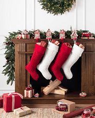  Mantel decorated with Christmas greenery and stockings
