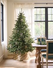 slim Christmas tree with decorations in the dining room