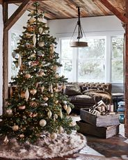 Artificial Christmas tree decorated with woodland-themed ornaments