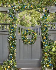 Yellow and blue flower wreath on fence