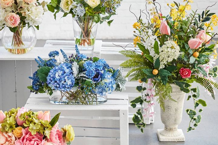 Assorted artificial flowers in vases