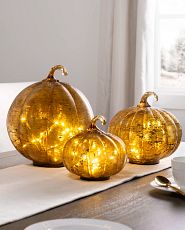 Set of lit glass pumpkin decorations