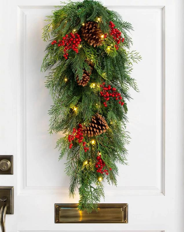 Artificial evergreen swag with red berries and pinecones