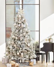 Frosted Christmas tree decorated with silver and glass ornaments