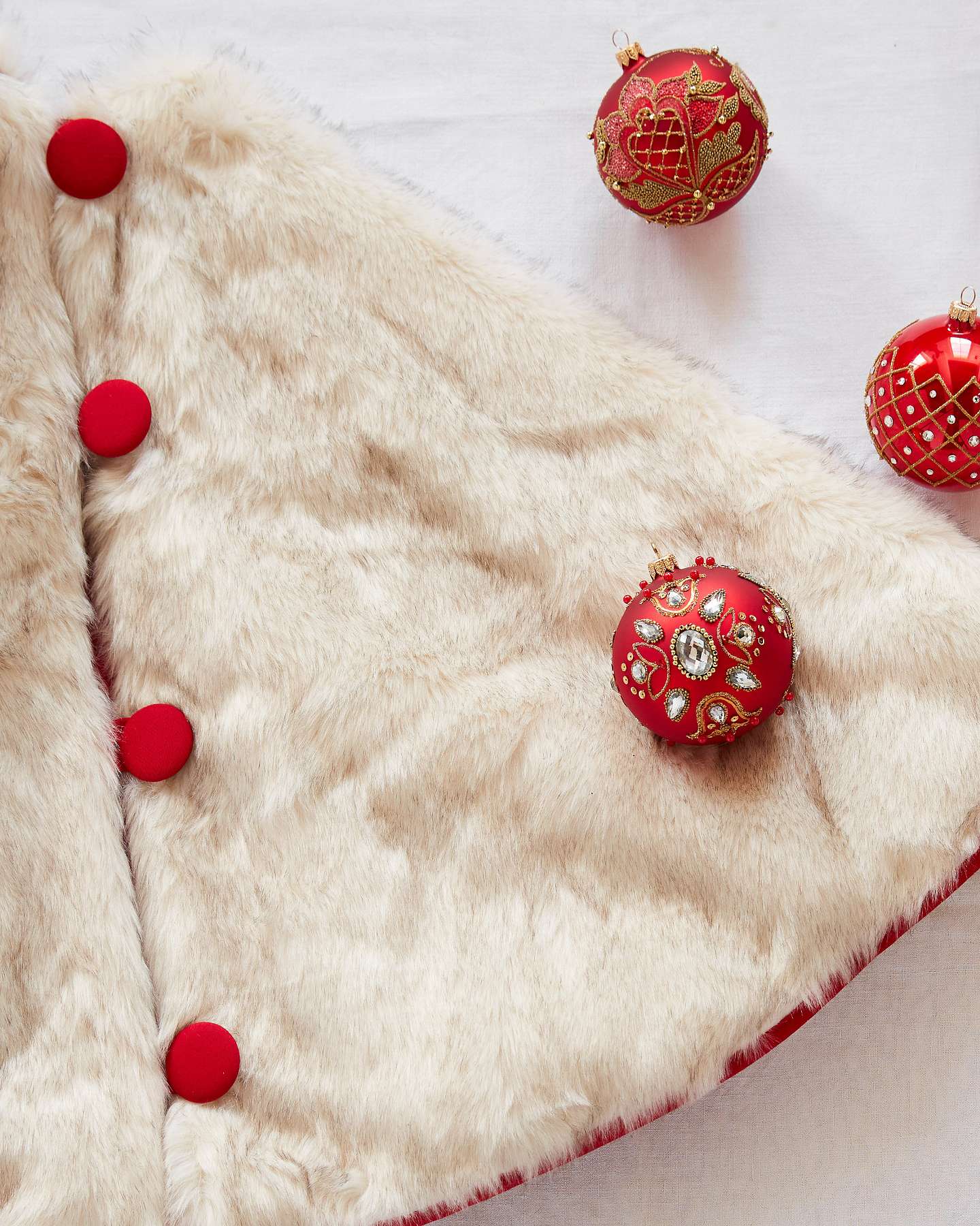 Balsam Hill Arctic Holiday Faux Fur Artificial Christmas Tree Skirt Lifestyle Display with Red Ornaments