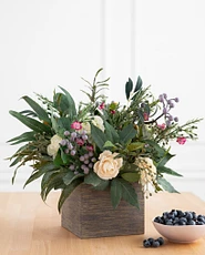 Artificial flower arrangement with ranunculus, waxflower blooms, and silver brunia