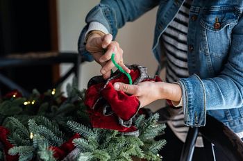 Hands tying ribbons with pipe cleaner