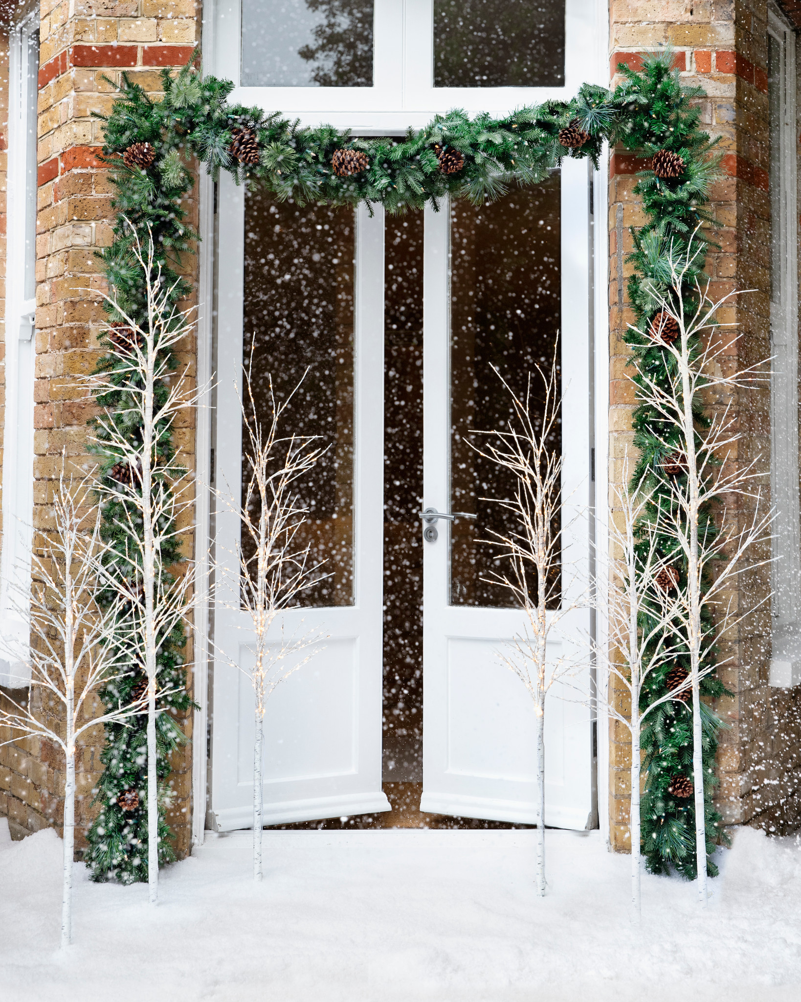 White double doors with artificial Christmas garland