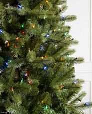 Closeup of artificial Christmas tree with multicolored LED lights