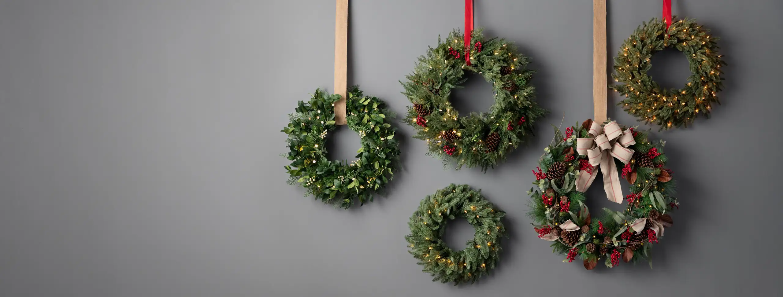 Assorted Christmas wreaths on wall