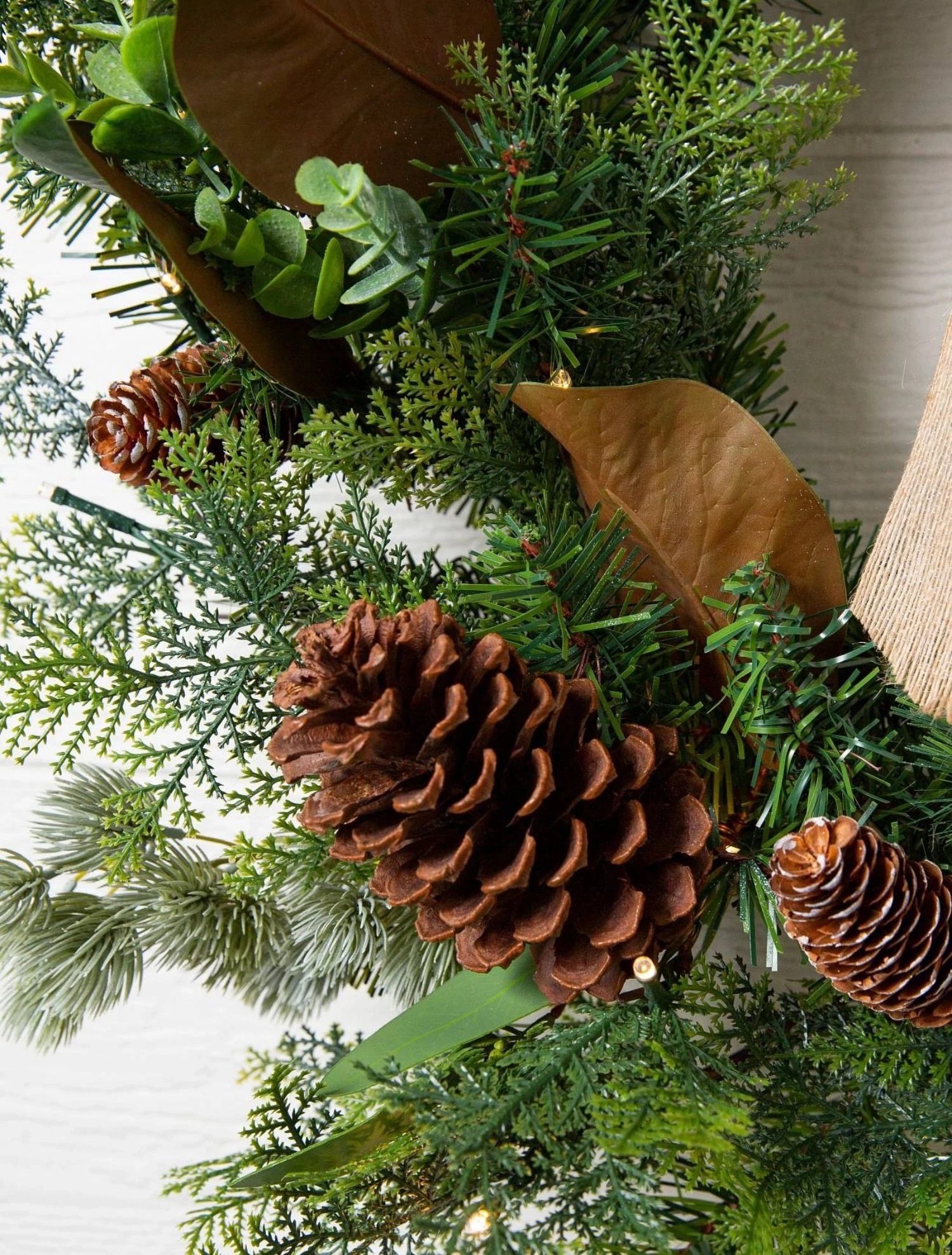 Traditional artificial Christmas greenery with pinecones