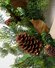 Traditional artificial Christmas greenery with pinecones