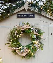 A shed decorated with a wreath and garland