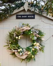 Decorated evergreen wreath on the front of a shed