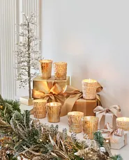 Votive candles in metallic glass holders