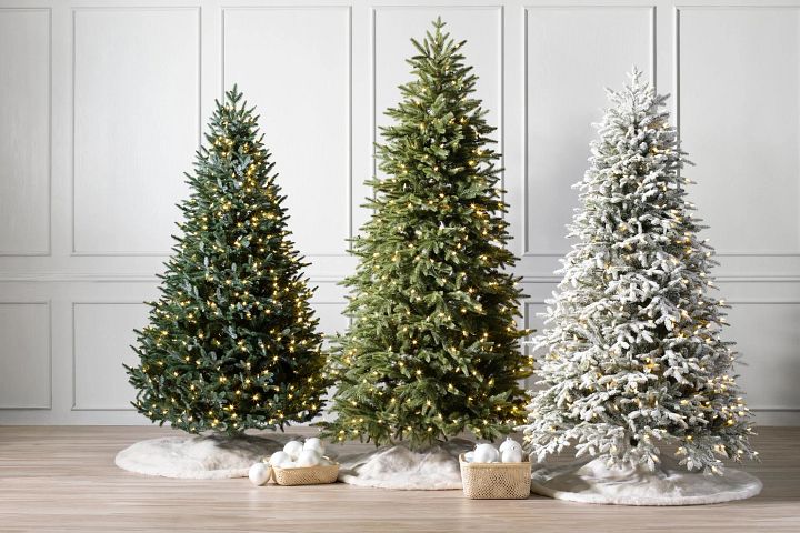 Trio of artificial Christmas trees pre-lit with clear LED lights