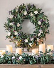 Multicolor floral wreath and garland on mantel