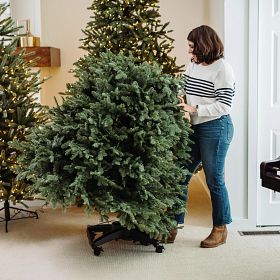Woman in living room about to flip the bottom section of Flip Tree