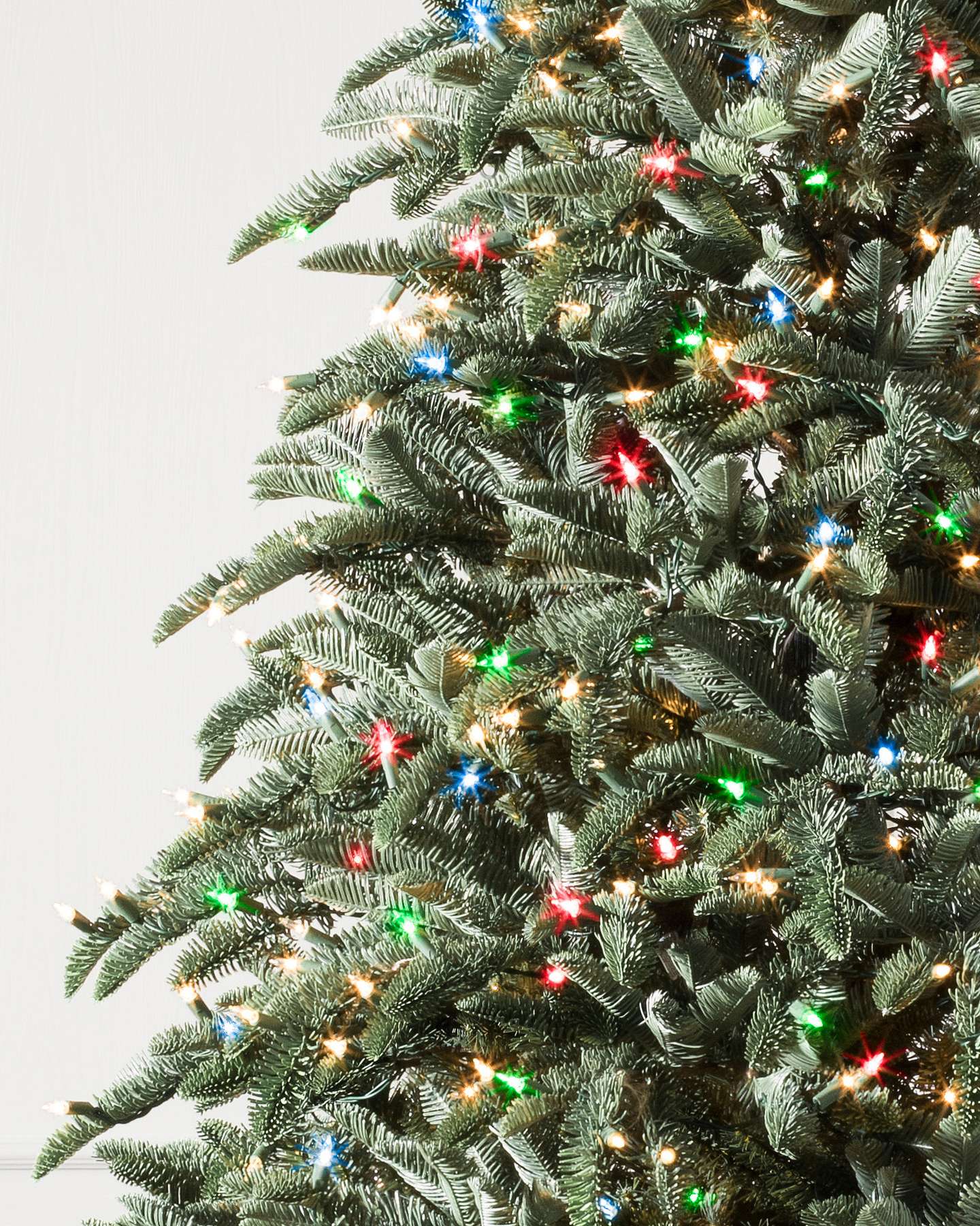 Balsam Hill Noble Fir Artificial Christmas Tree Close-Up Highlighting Lifelike Branch Tips and LED Lights