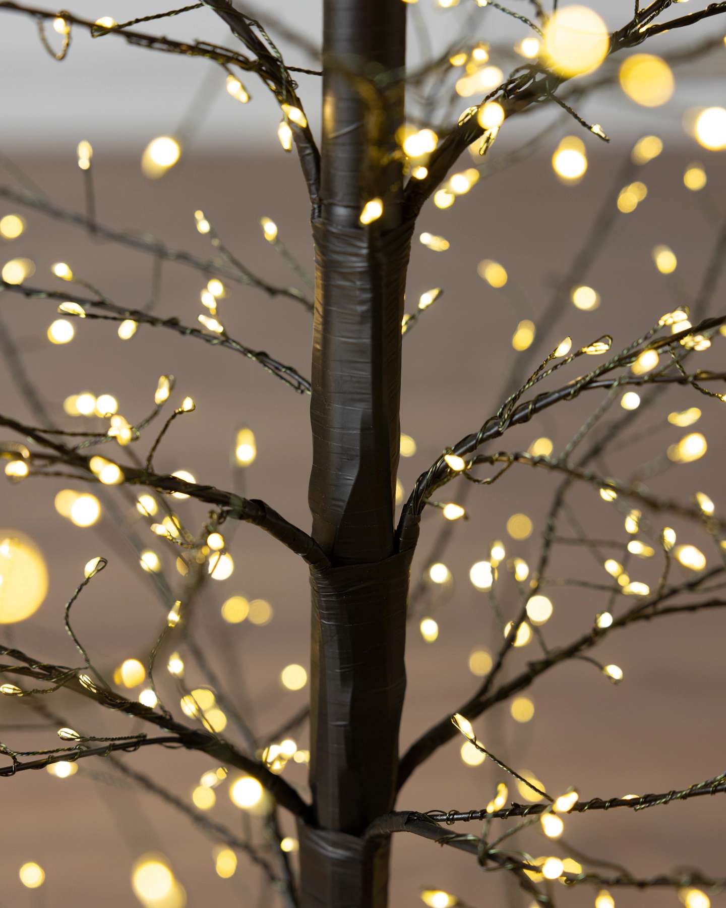 Balsam Hill 5-Foot Black Outdoor Fairy Light Twig Artificial Christmas Tree Trunk Closeup