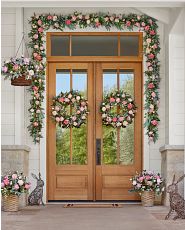 Front porch decorated with pink flower wreaths, garlands, and hanging baskets