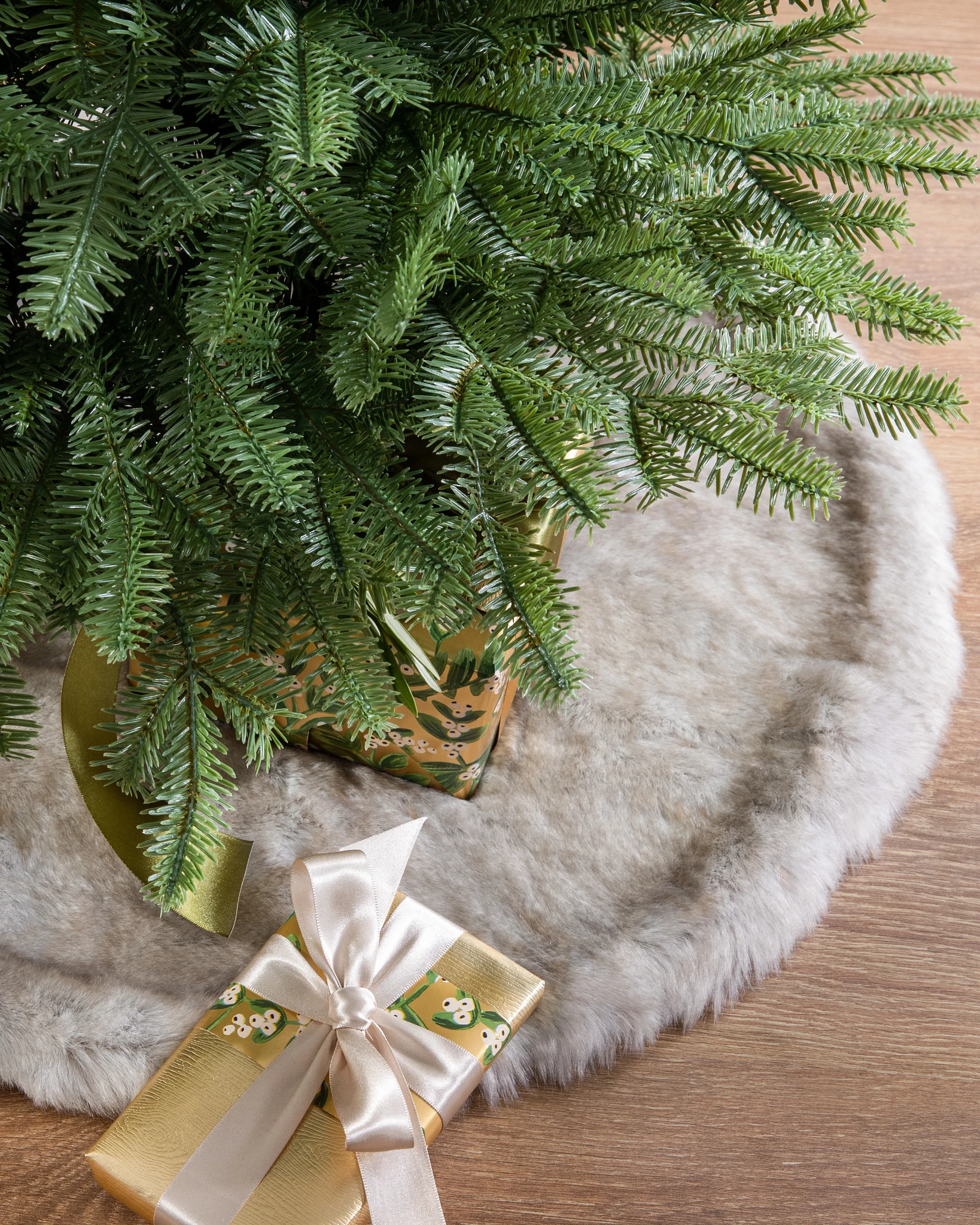 Faux fir tree skirts in gray, brown, and ivory colors