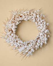 Spring wreath made with artificial white forsythia blooms and buds with light brown stems