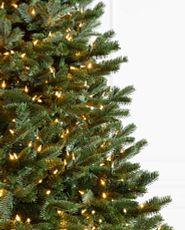 Close-up image of artificial Christmas tree with clear lights.