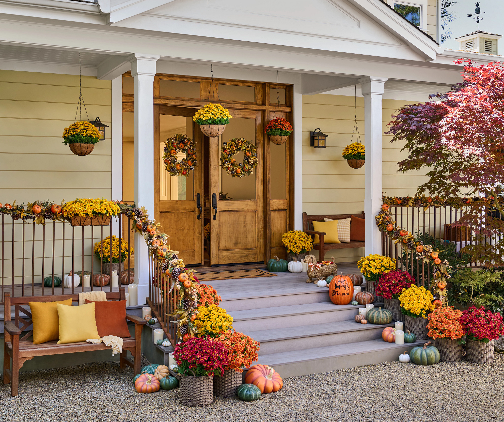  Thanksgiving entryway idea with fall foliage, pumpkins, and flameless candles