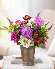 Artificial flower arrangement with faux hellebores, lilacs, and lavender in a silver ceramic pot