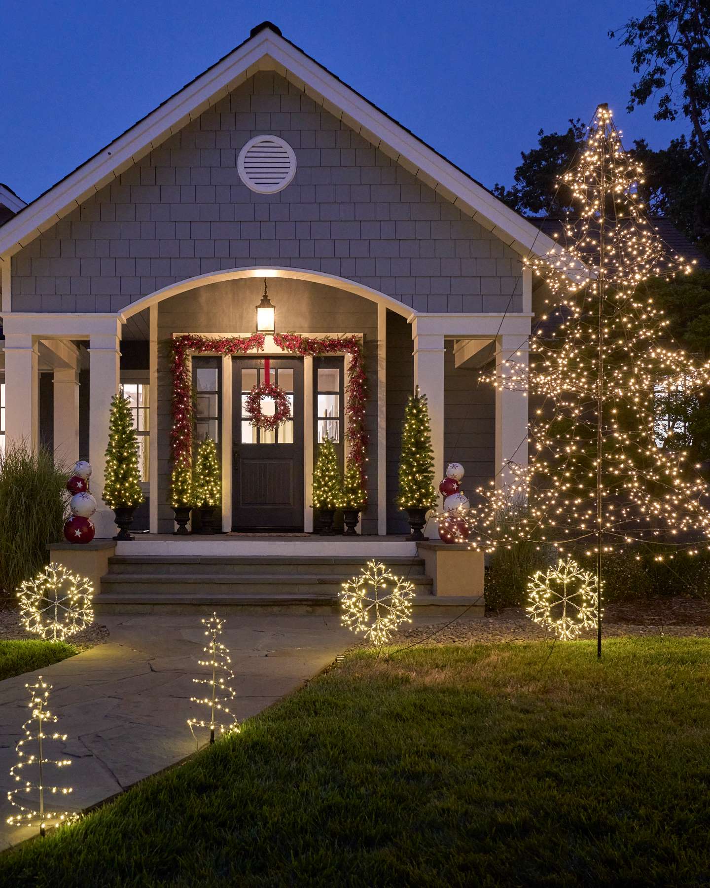 Balsam Hill Outdoor Snowflake Pathway Lights Illuminating a Garden Path