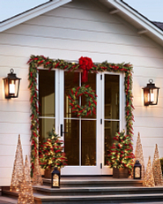 Patio decorated with pre-lit artificial greenery and lanterns