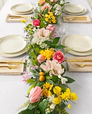 Artificial flower garland with poppies, orchids, freesia, and tulips