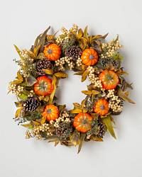 Autumn wreath decorated with pumpkins, berries, and pinecones