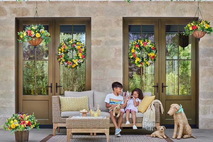 Outdoor lounge area decorated with spring flowers and accents