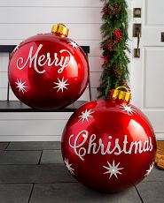 Pair of oversized red Christmas balls inscribed with “Merry” on one and “Christmas” on the other