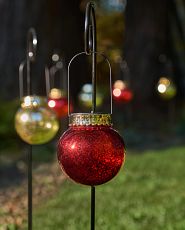 Pair of red oversized ornaments with Merry and Christmas words on each