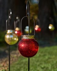 Pair of red oversized ornaments with Merry and Christmas words on each