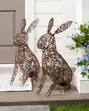 A pair of rabbit wire sculpture decorations on a porch step