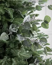 Closeup of artificial eucalyptus sprigs on a Christmas tree