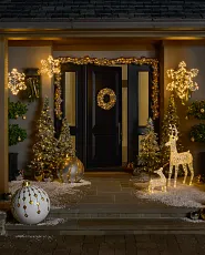 Holiday front door décor idea with silver and gold ornament wreaths and garlands