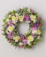 Artificial flower wreath with lilasc, roses, lavender, and hydrangeas