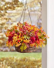 Hanging basket with artificial fall leaves