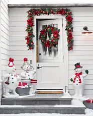 Doorway decorated with holiday wreath, garland, and accents