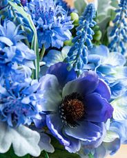 Closeup of artificial blue cornflowers and hydrangeas