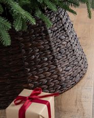 Brown woven tree collar under a Christmas tree