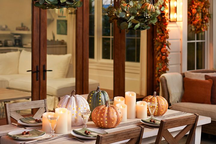 Outdoor dining area with fall themed themed decor